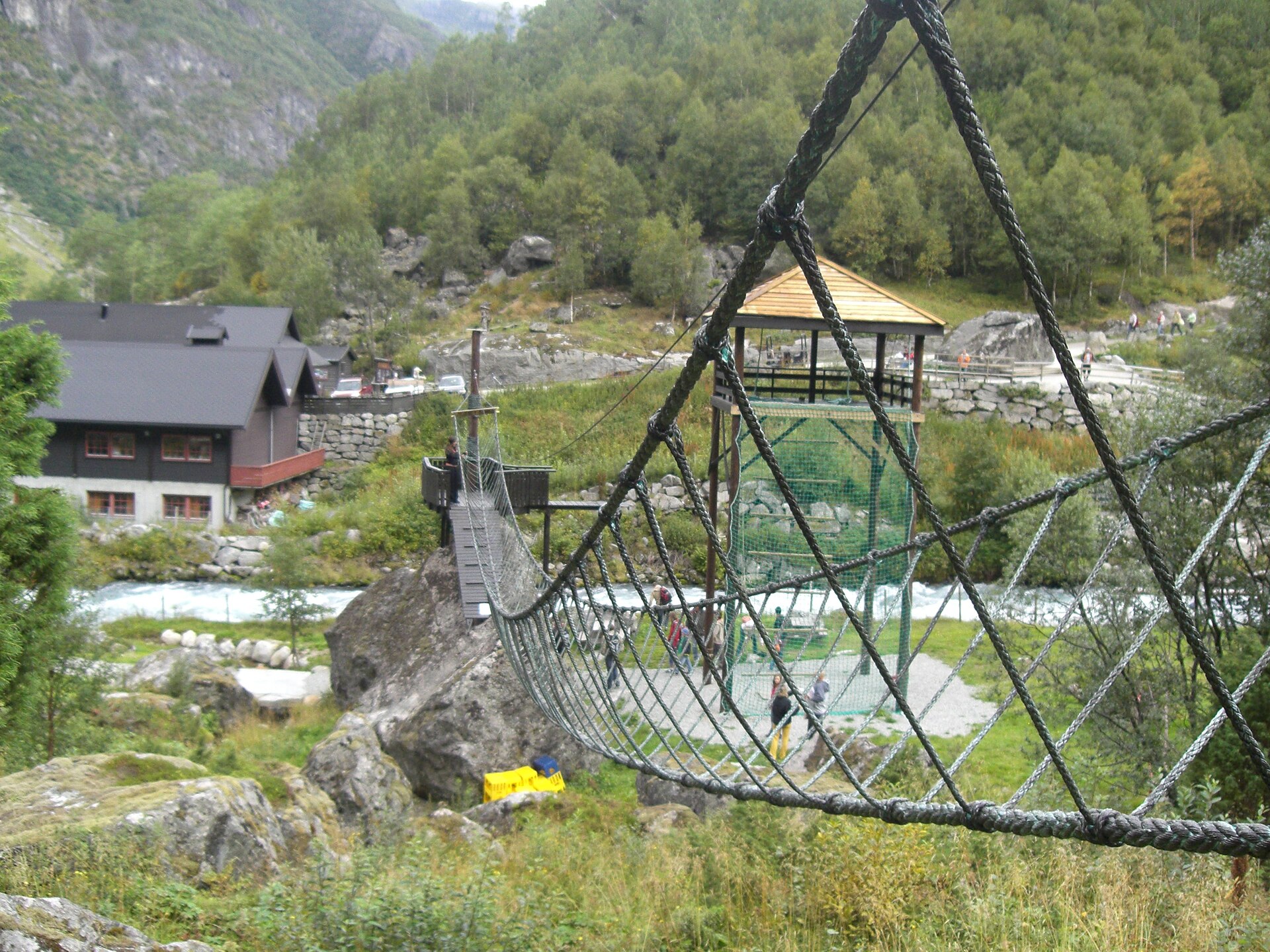 Footbridge on the walking trail near Briksdal Glacier, showing the outdoor walking section of the excursion